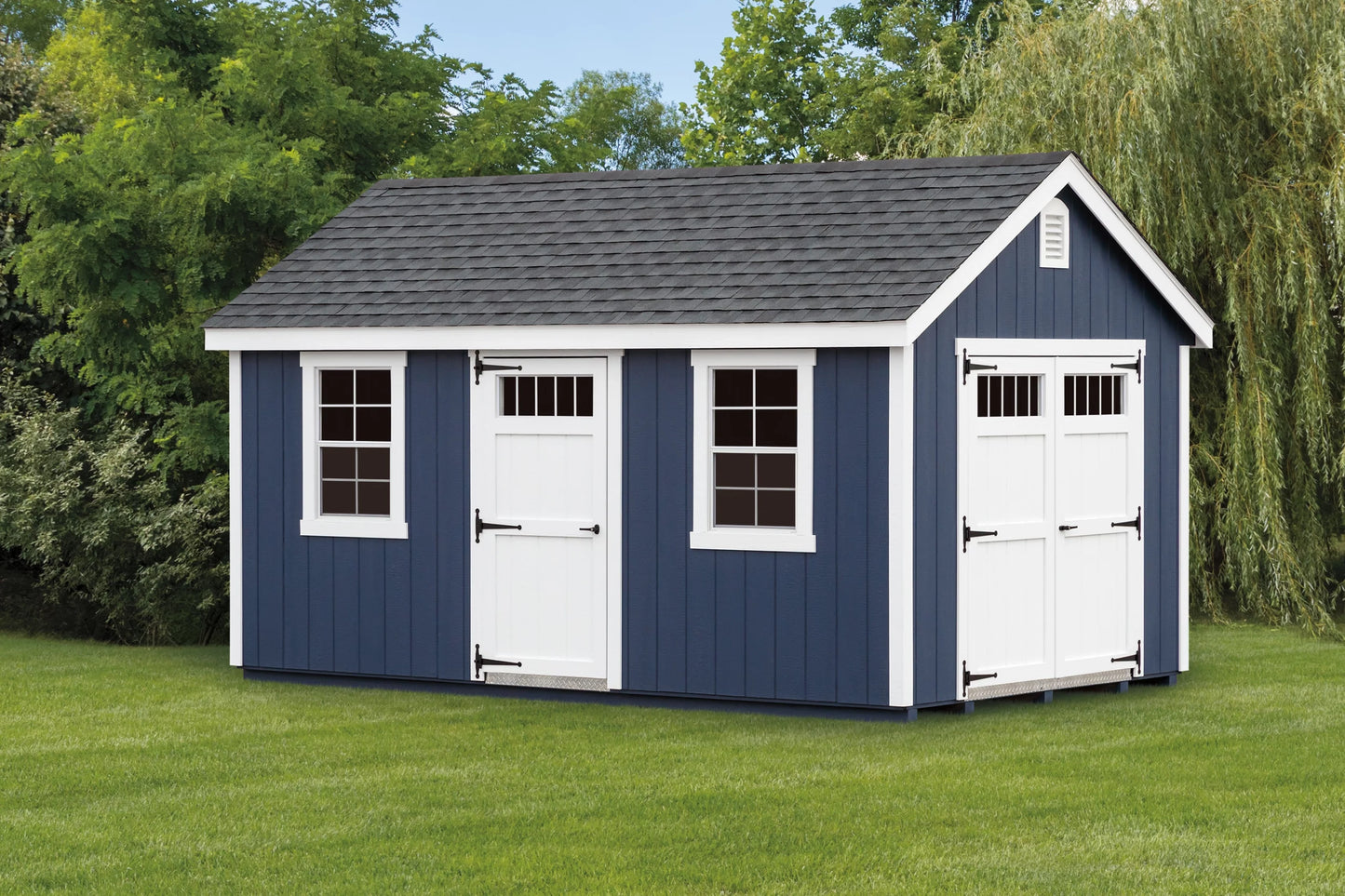 Blue storage shed with white doors on a grassy area with trees in the background