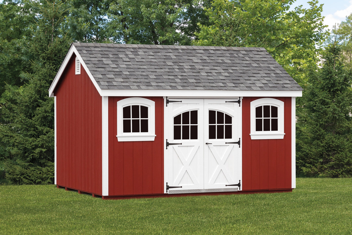 Red storage shed with white trim in a grassy area with trees