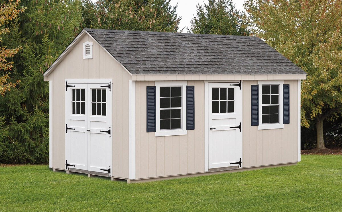 Beige storage shed with white doors and windows in a garden setting