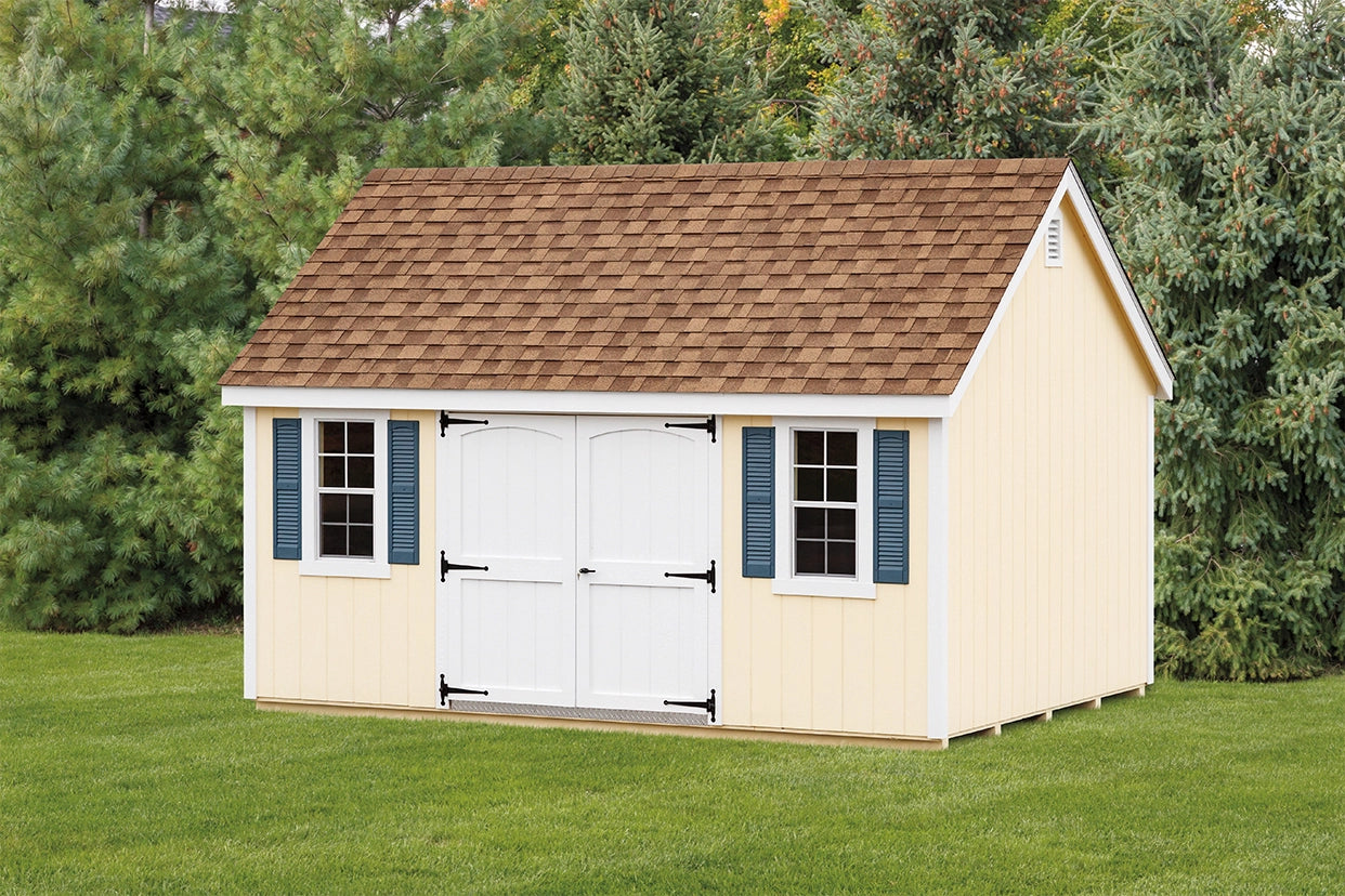 Wooden shed with a brown roof and white doors on a grassy area with trees in the background