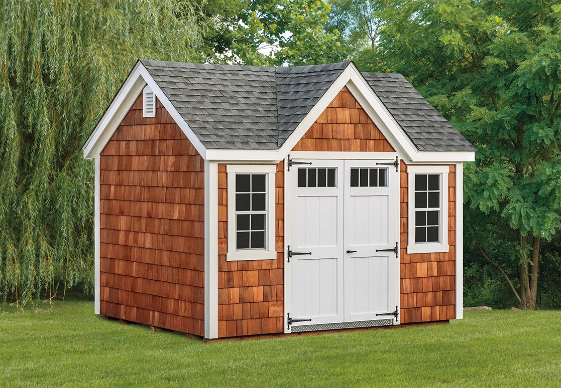 Wooden shed with a gray roof in a garden setting