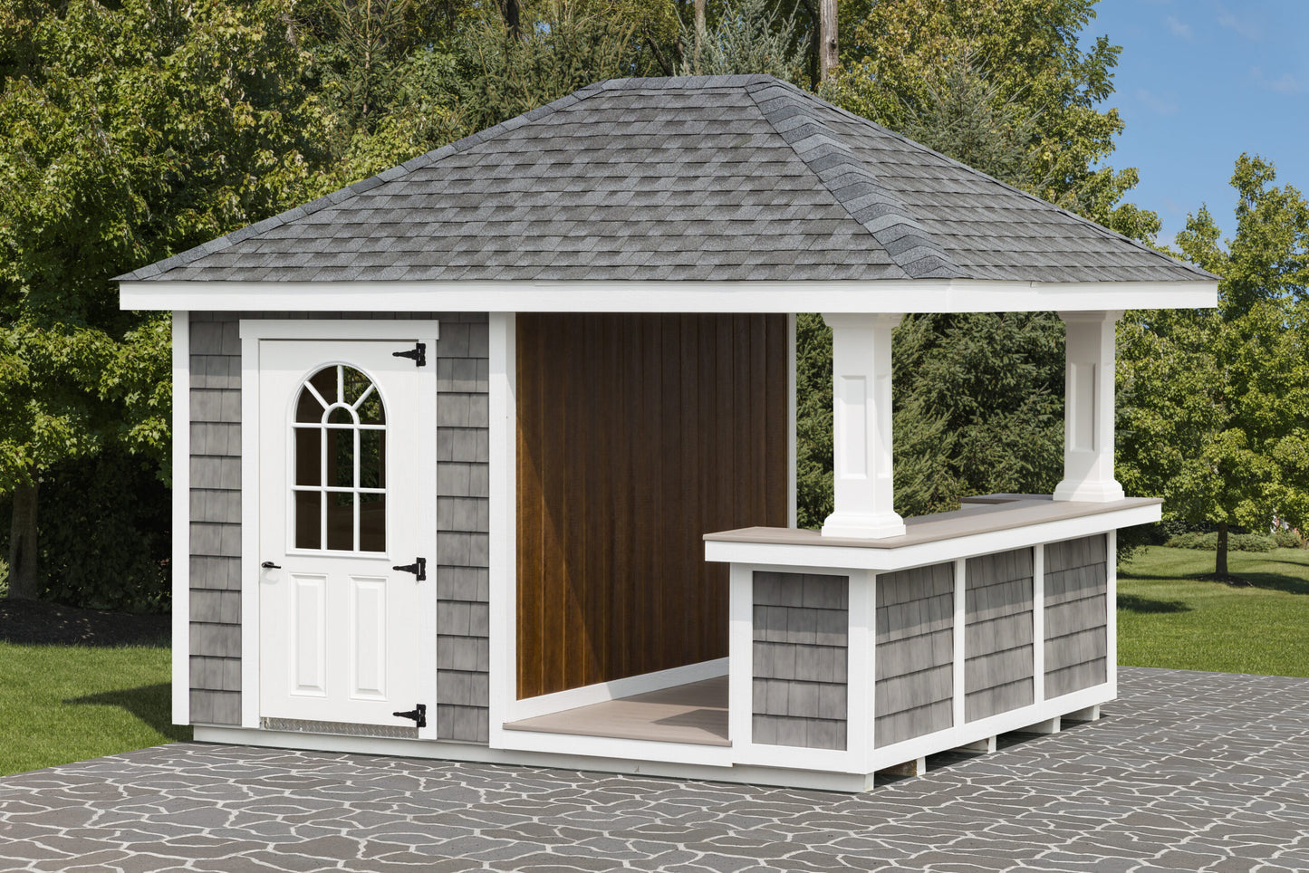 Small outdoor shed with a gray roof and white door in a garden setting.