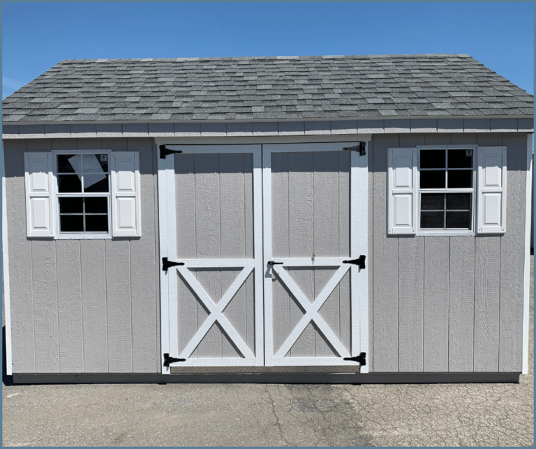 A 10x14 traditional shed with gray and white siding, double doors with white shutters, and a gable roof.