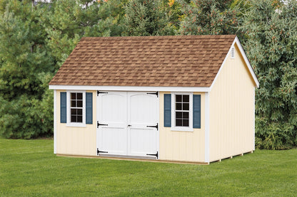 Wooden shed with a brown roof and white doors on a grassy area with trees in the background