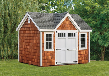 Wooden shed with a gray roof in a garden setting