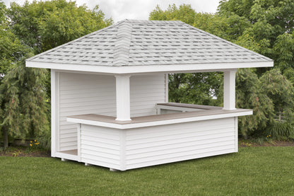 White wooden gazebo with a roof in a garden setting