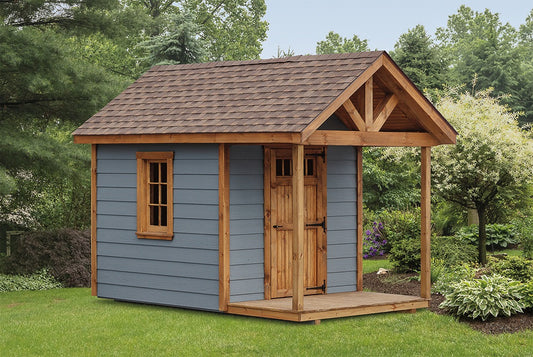 Wooden playhouse with a blue exterior and brown roof in a garden setting.