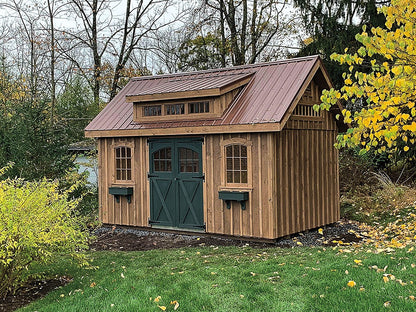 Wooden shed with a brown roof in a garden setting with trees and grass.